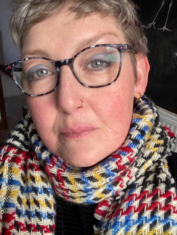 Woman wearing glasses and patterned scarf