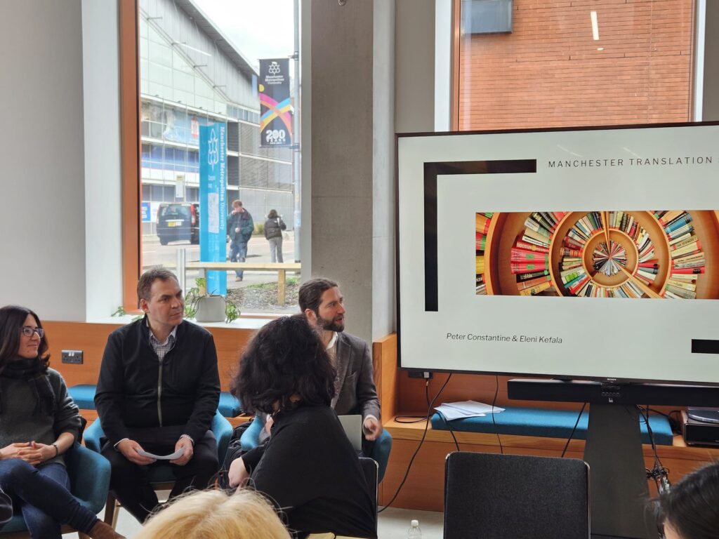 A group of people looking at a screen